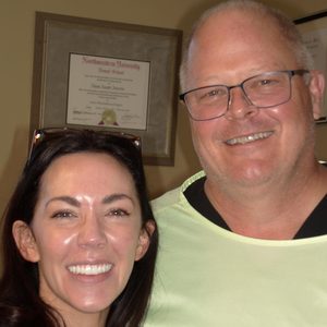 Dr. Janette with a patient beside his Northwestern residency certificate